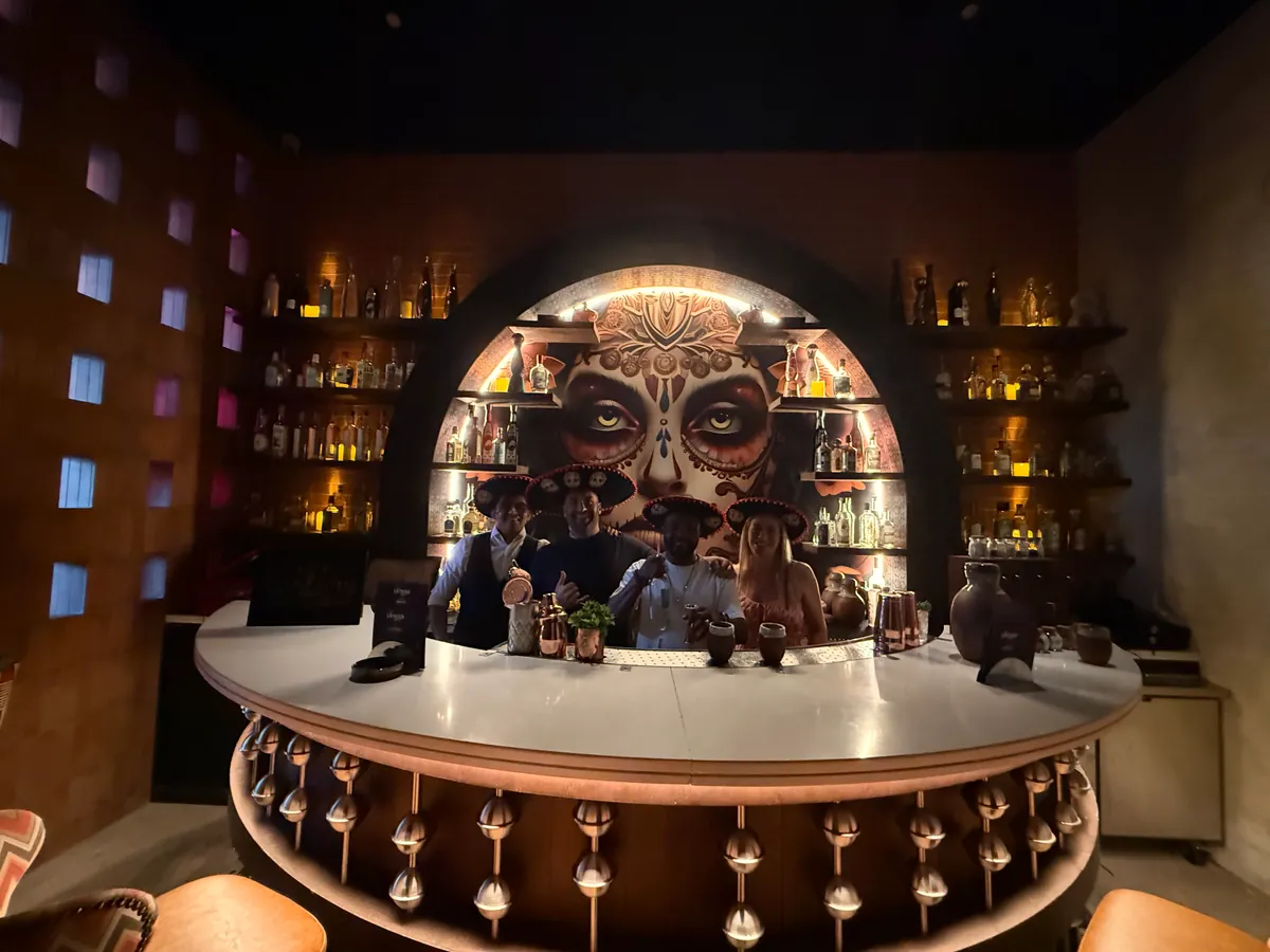 The agave bar at Barbossa, Yas Bay — the La Catrina mural behind a full back bar, the team at the pass