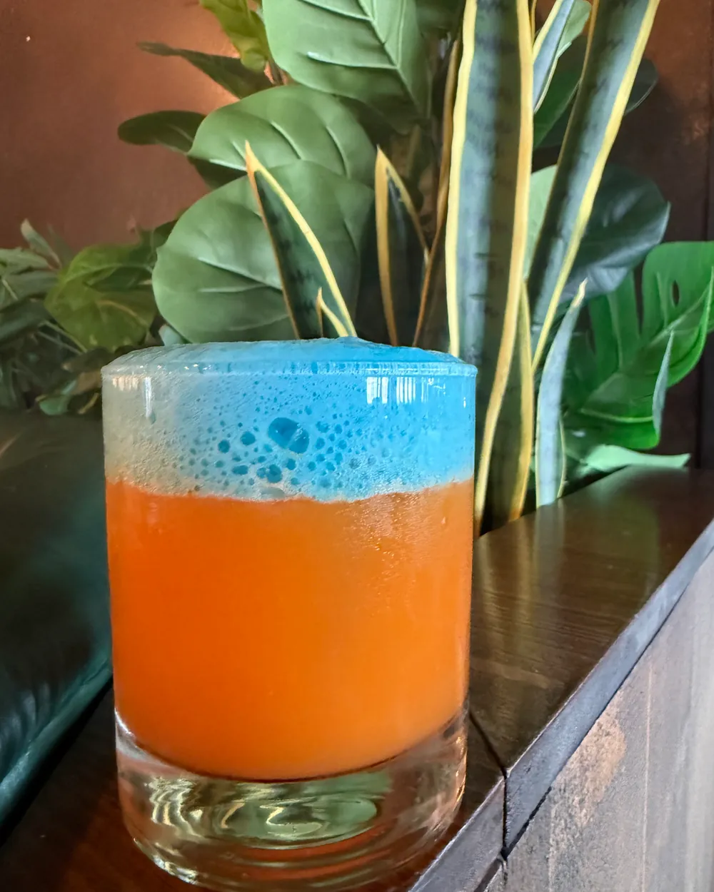Pour Decisions — acid-rectified orange under a stabilised blue pandan foam, served over clear rock